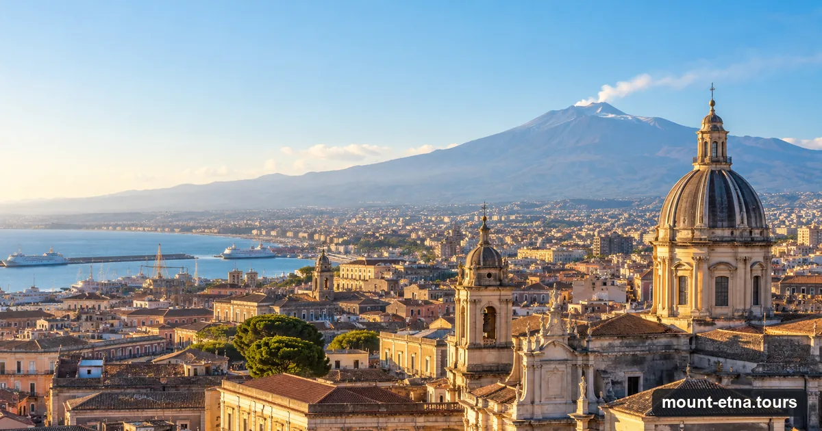 Catania's baroque domes and rooftops with Mount Etna rising behind the city