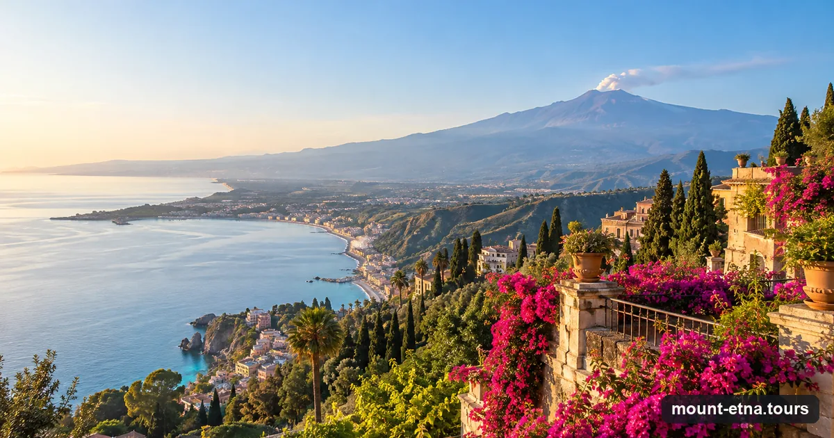 The bay below Taormina with bougainvillea in the foreground and Mount Etna on the horizon